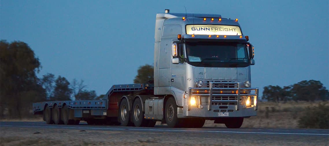 Road train hauling hay bales